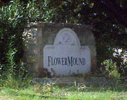 "Flower Mound Sign" by AshTR - Flickr: Flower Mound Sign. CC BY-SA 2.0 via Commons.